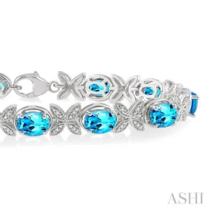 1/10 Ctw Round Cut Diamond & 7x5MM Oval Cut Blue Topaz Semi Precious Bracelet in Sterling Silver