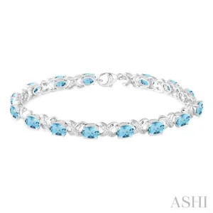 7x5 mm Oval Cut Blue Topaz and 1/20 Ctw Round Cut Diamond Fashion Bracelet in Sterling Silver