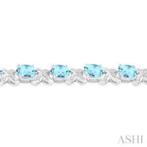 7x5 mm Oval Cut Blue Topaz and 1/20 Ctw Round Cut Diamond Fashion Bracelet in Sterling Silver