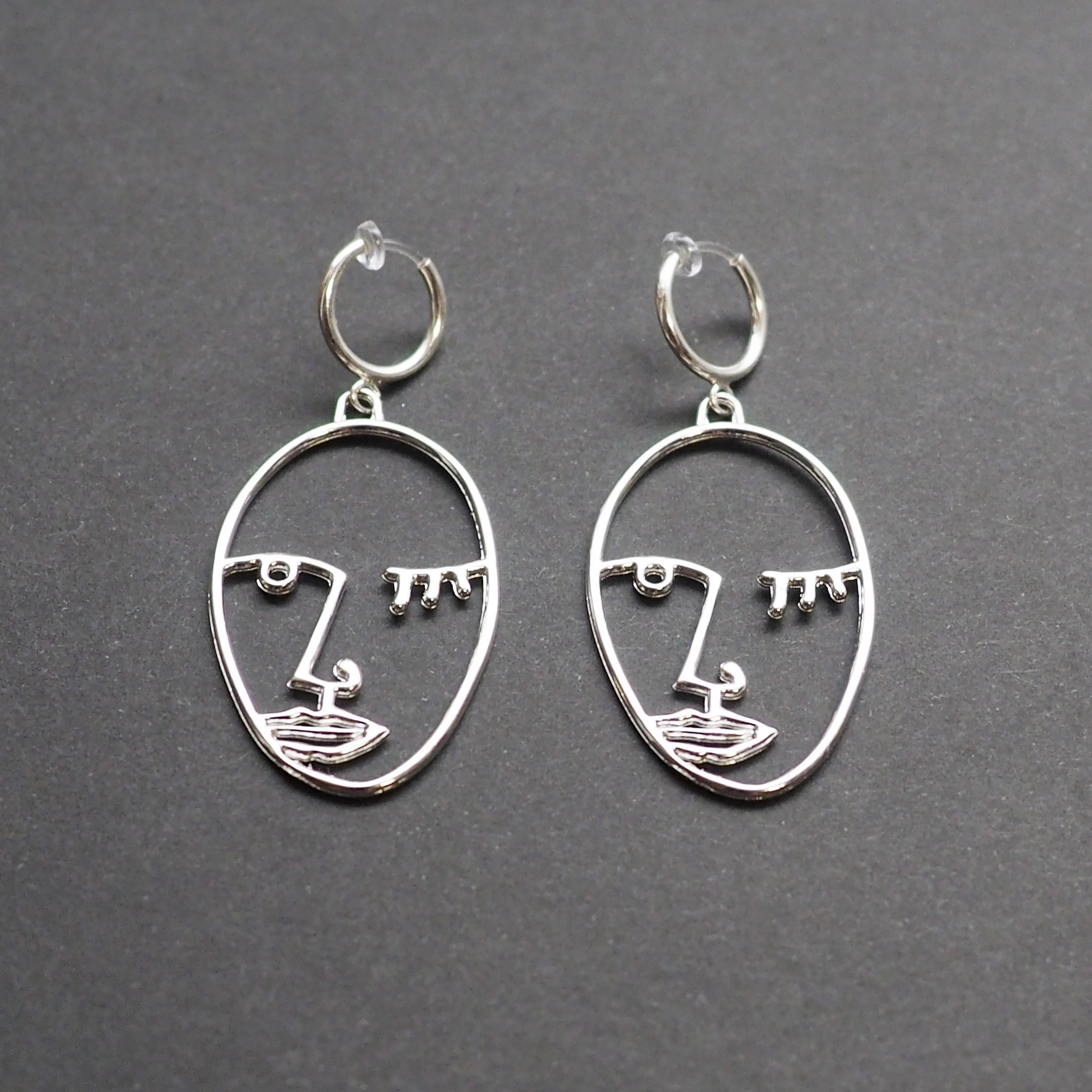 Silver Picasso human face clip on hoop earrings