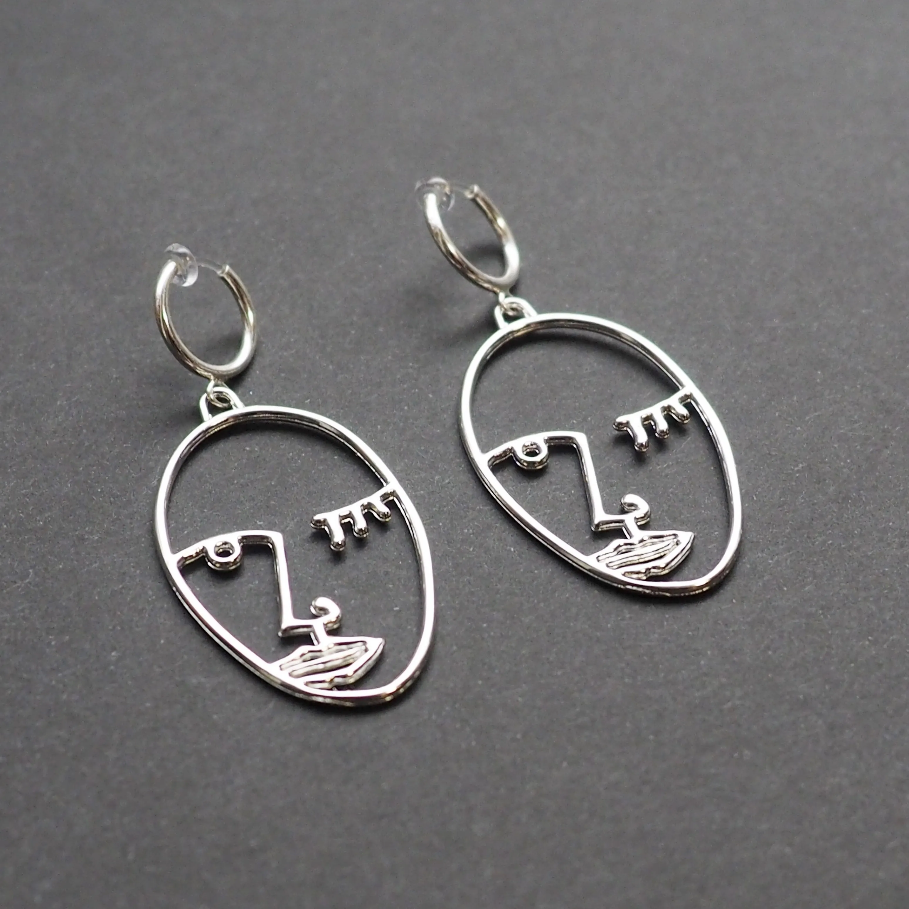 Silver Picasso human face clip on hoop earrings